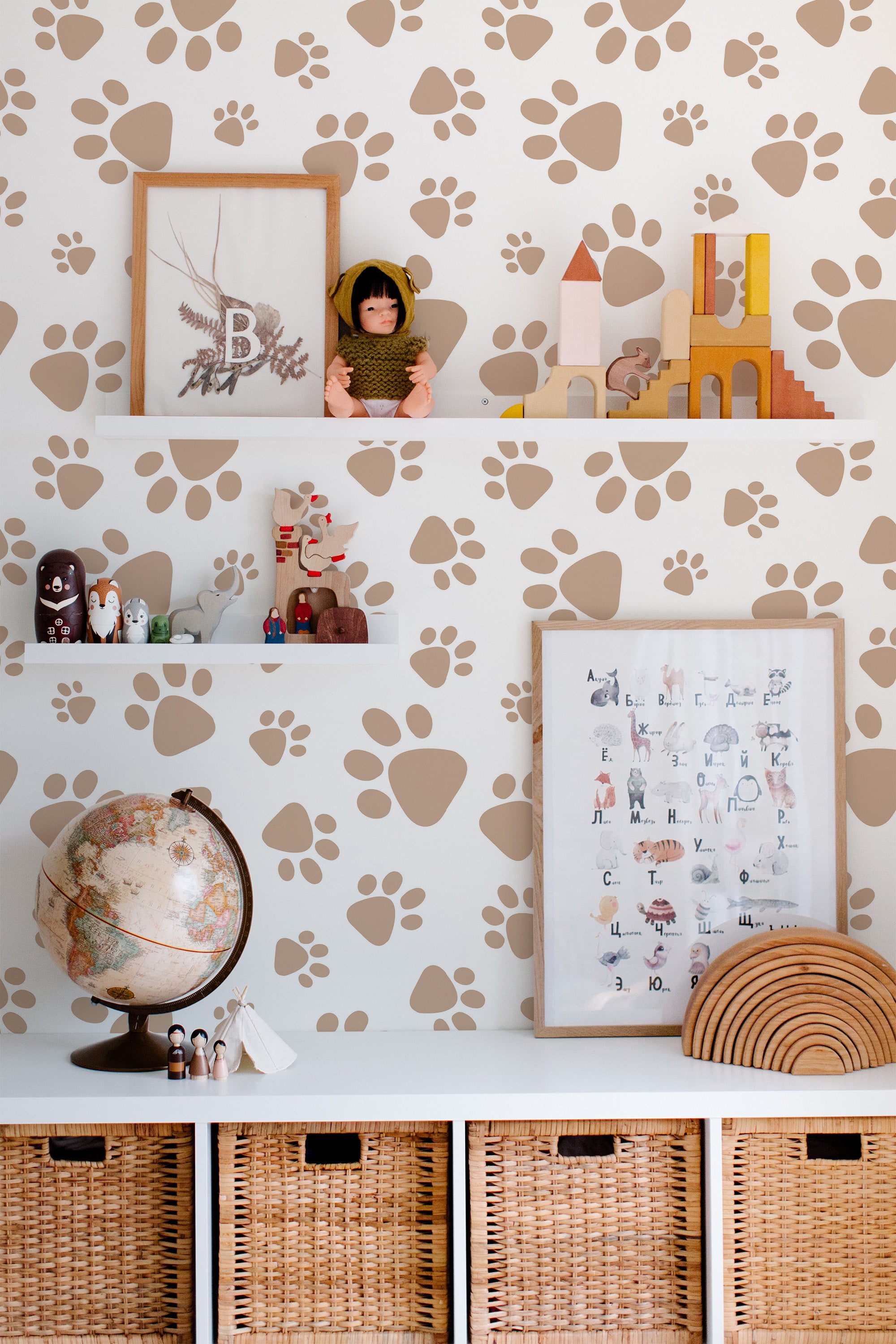 Self-adhesive wallpaper with dog paw print pattern in shades of brown on a white background, decorating a children's room.
