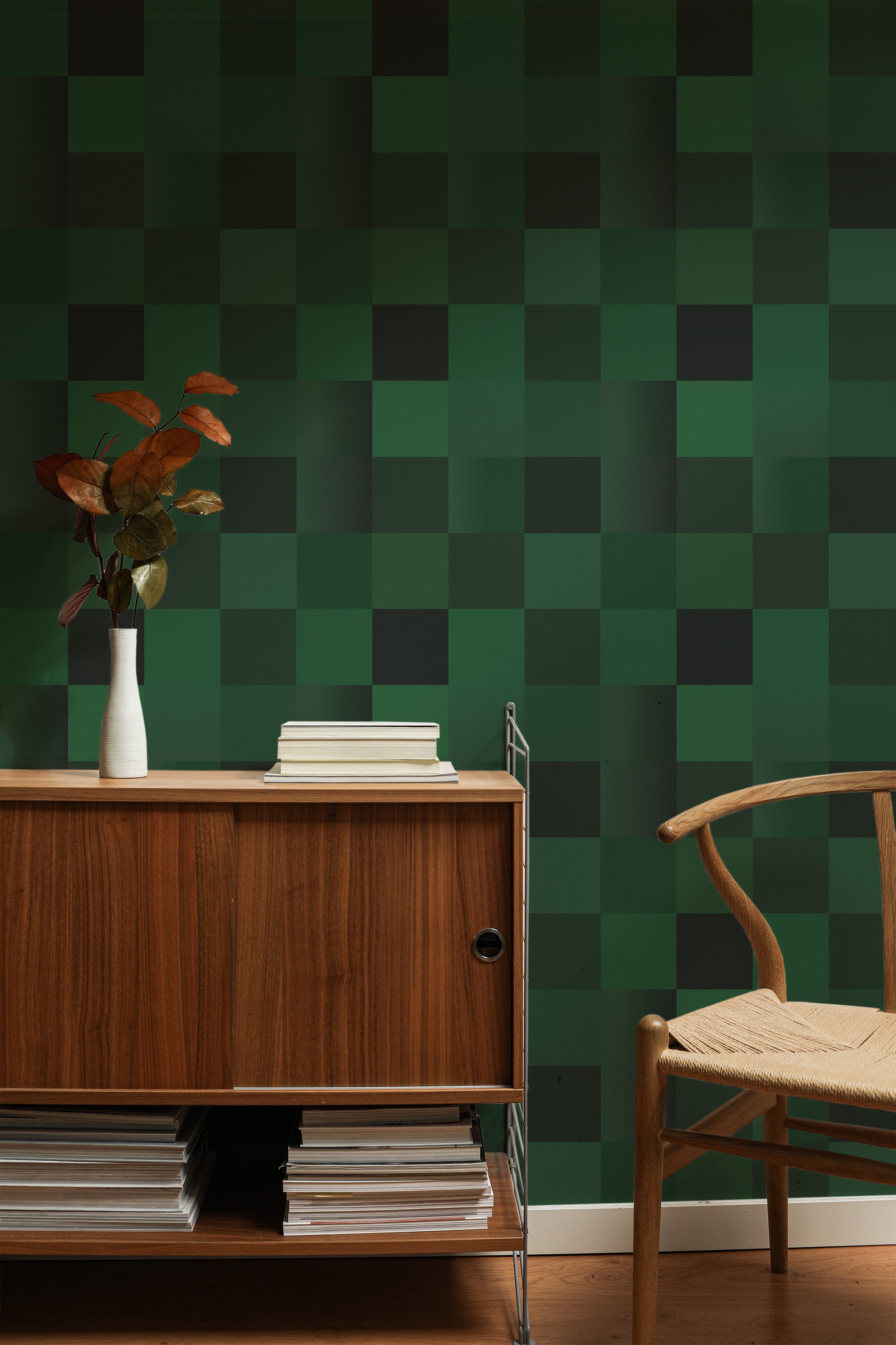 Self-adhesive dark green tile pattern wallpaper in a room with a wooden sideboard and chair, and decorative plant on top.