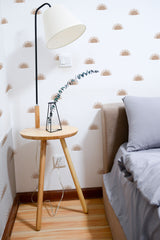 Self-adhesive Boho half sun wallpaper in warm tones on a white background, accentuating a cozy bedroom corner with a floor lamp and wooden side table.