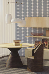 A room with striped print wallpaper in varying shades of blue and grey, with wavy contours and alternating spacing, creating a modern twist on traditional wallpaper.