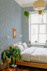 A room with walls adorned in Tiny blue floral wallpaper, including small blue flowers scattered on a white background, giving the space a fresh and traditional wallpaper feel.