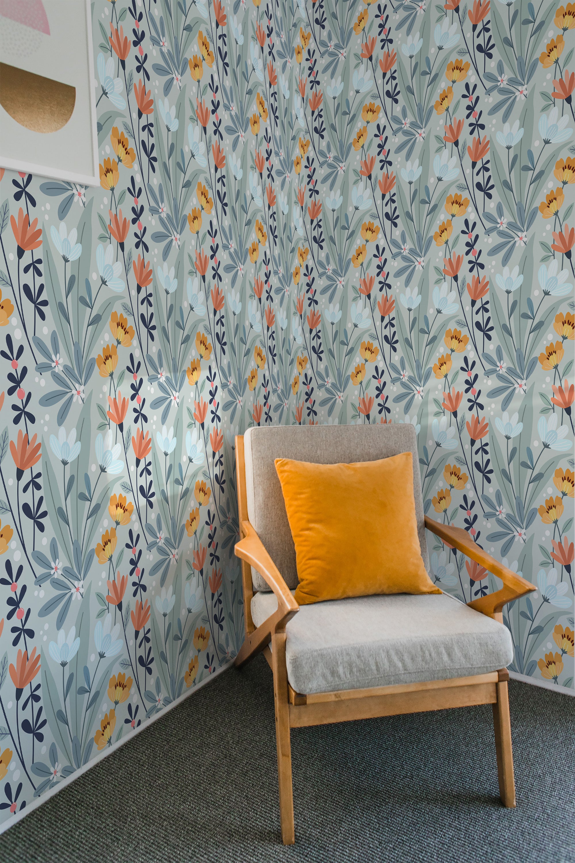 A room with a corner wall covered in Spring-themed wallpaper with a pattern of stylized flowers and leaves in shades of orange, blue, and gray, accompanied by an armchair with a yellow cushion, completing a bright, traditional wallpaper setting.