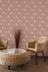 Self-adhesive Boho rainbow patterned wallpaper with arches in alternating shades on a dusty rose background in a room with wicker furniture.