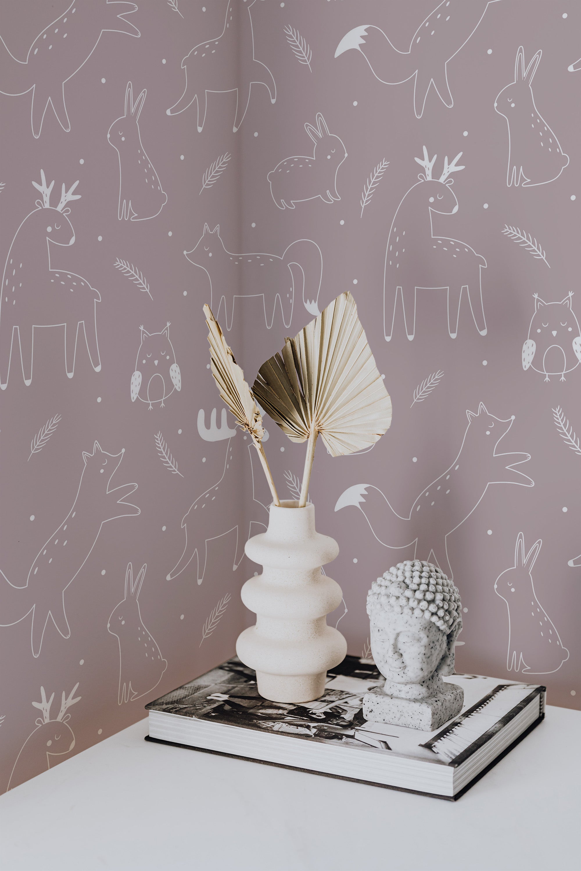 Self-adhesive wallpaper with whimsical illustrations of forest animals, including bears, foxes, rabbits, and owls, in a monochromatic style on a pale pink background.