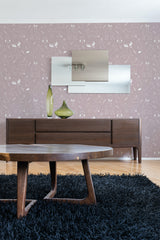 A room with a sideboard and table in front of a wall covered in brown wallpaper with a repeated pattern of white line-drawn forest animals such as deer, rabbits, and squirrels, embodying a traditional wallpaper design.