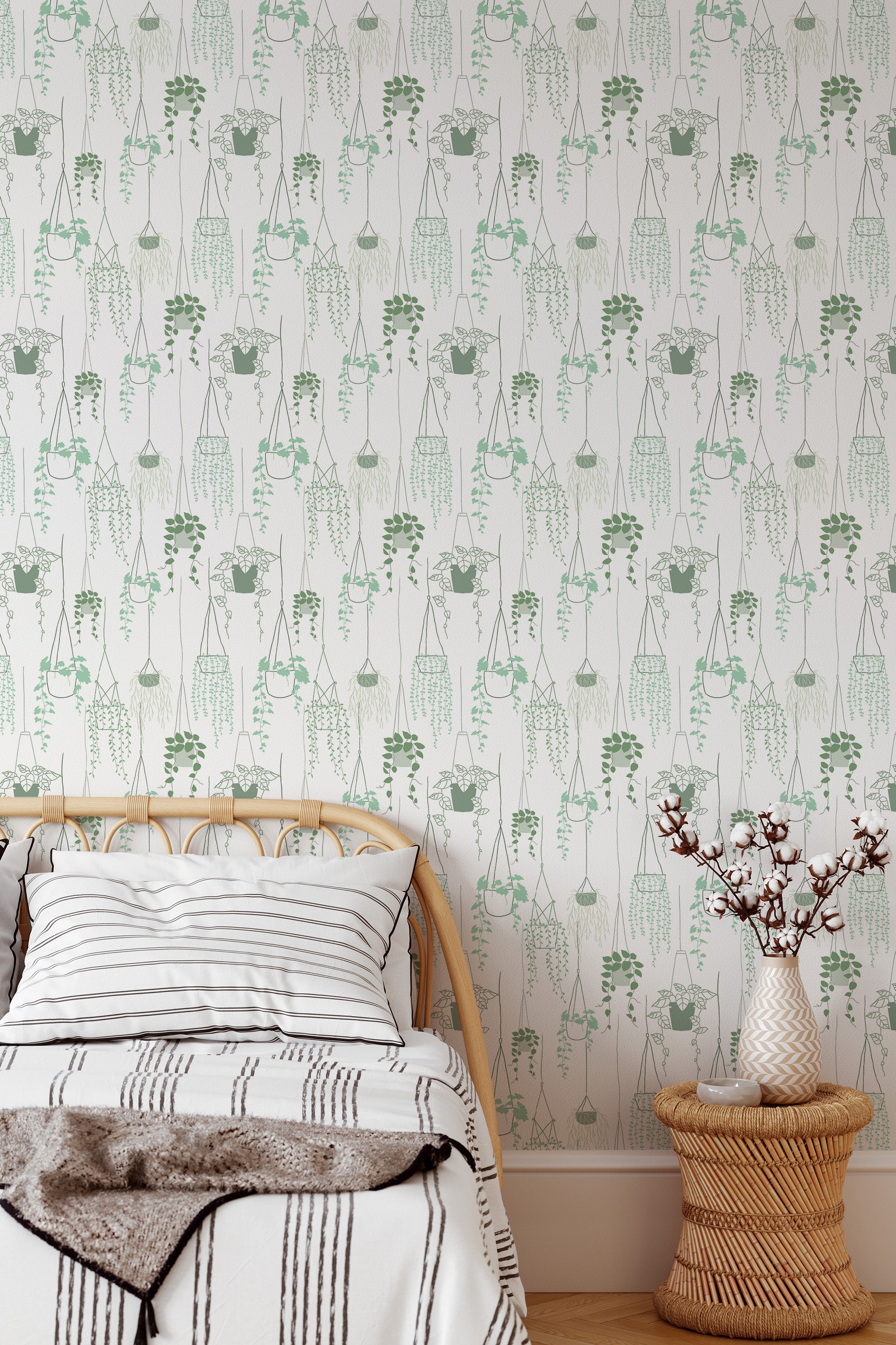 Self-adhesive wallpaper with a pattern of hanging potted plants in green on an off-white background in a bedroom setting.