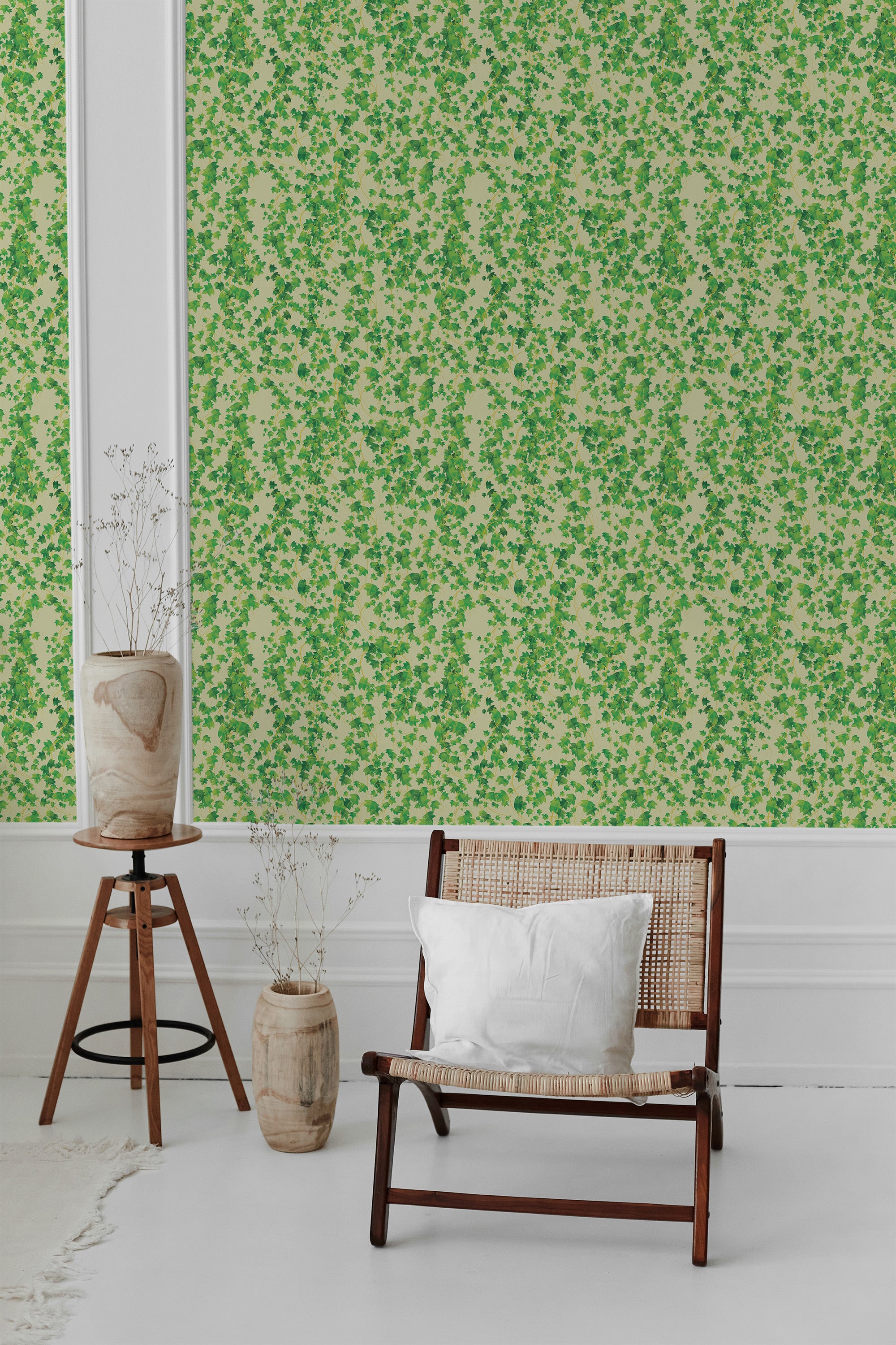 A room with green 'Natural' patterned wallpaper with small leaf-like motifs, white molding, and a wooden chair with a white cushion in front, traditional wallpaper.