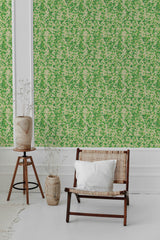 A room with green 'Natural' patterned wallpaper with small leaf-like motifs, white molding, and a wooden chair with a white cushion in front, traditional wallpaper.