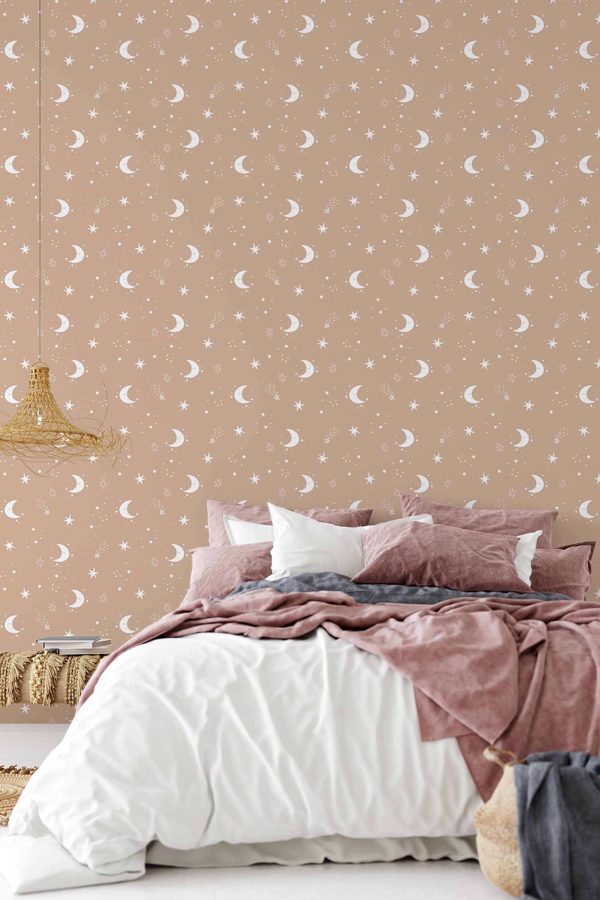 A bedroom with walls covered in beige wallpaper adorned with white crescent moons, complementing a cozy bed with pink and white bedding, traditional wallpaper.