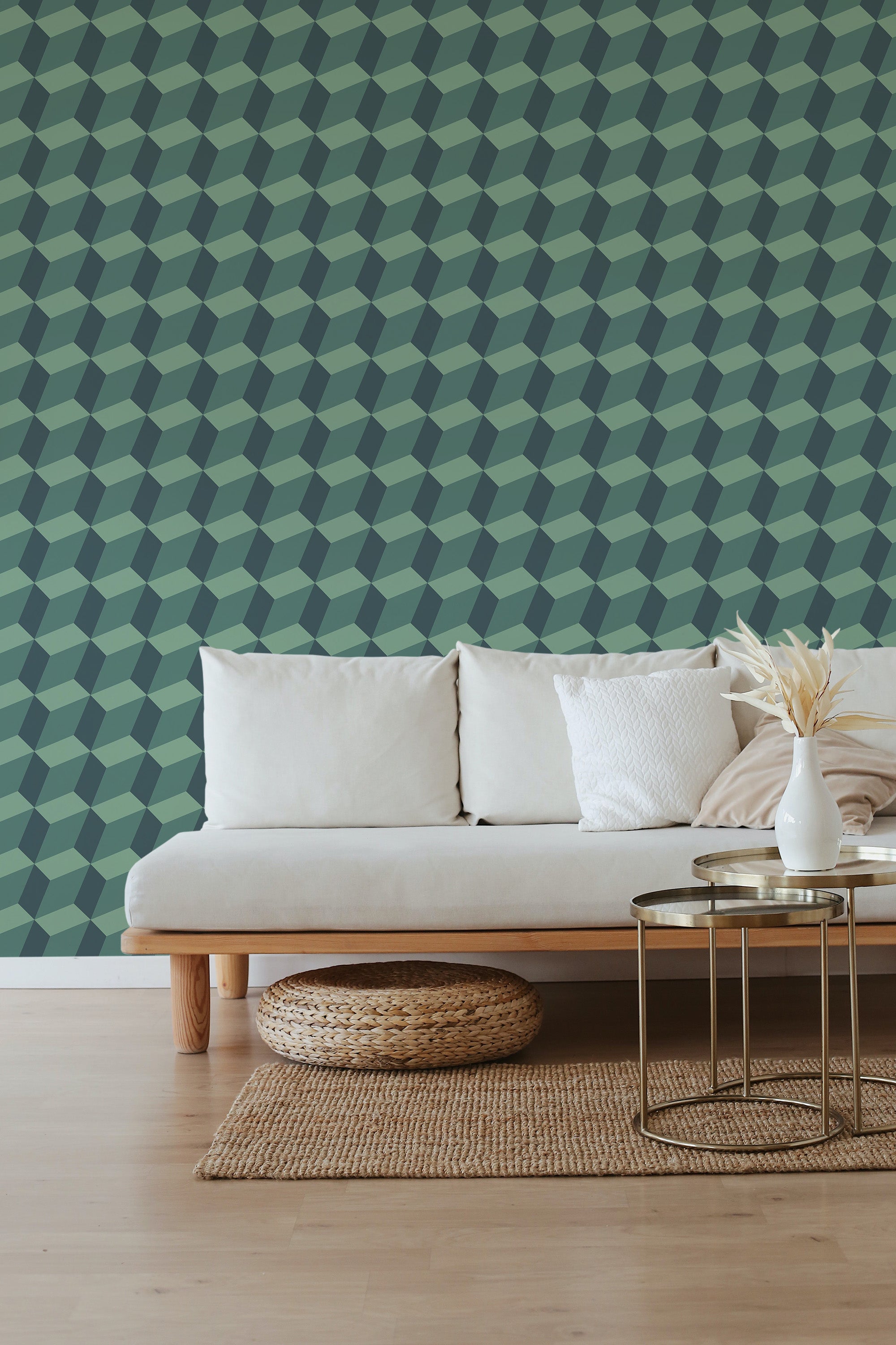 A room with a wall covered in Bold Luxury patterned wallpaper with geometric shapes in various shades of green, complemented by a neutral-toned sofa in front, traditional wallpaper.