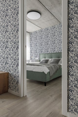 Floral-patterned wallpaper with a blue and white color scheme, enhancing the room's cozy ambiance. The design reflects a retro farmhouse aesthetic, evoking a timeless charm and comfort. Traditional wallpaper.