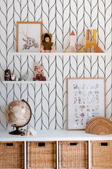 Self-adhesive wallpaper with a knitted stripe design featuring vertical black lines curving in a wave pattern on a white background, giving a modern, cozy feel to the room.