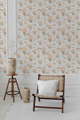 Whimsical wallpaper with a repeating pattern of vintage hot air balloons, soft pastel-colored clouds, and muted rainbows in nature-inspired hues, covering the wall of a room with a cozy chair and minimalistic d��cor. Traditional wallpaper.
