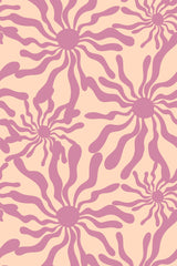 A repeating pattern of stylized suns with wavy purple rays on a light beige background, creating a playful and vibrant design. Peel and stick removable wallpaper.