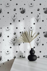 Self-adhesive wallpaper with a celestial design, displaying black and white illustrations of trees, moons, and geometric shapes, arranged in a repeating pattern with dots scattered throughout.