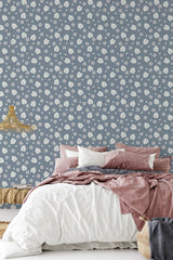 Blue wallpaper adorned with small white floral patterns, giving the room a cozy and rustic farmhouse feel. Traditional wallpaper.