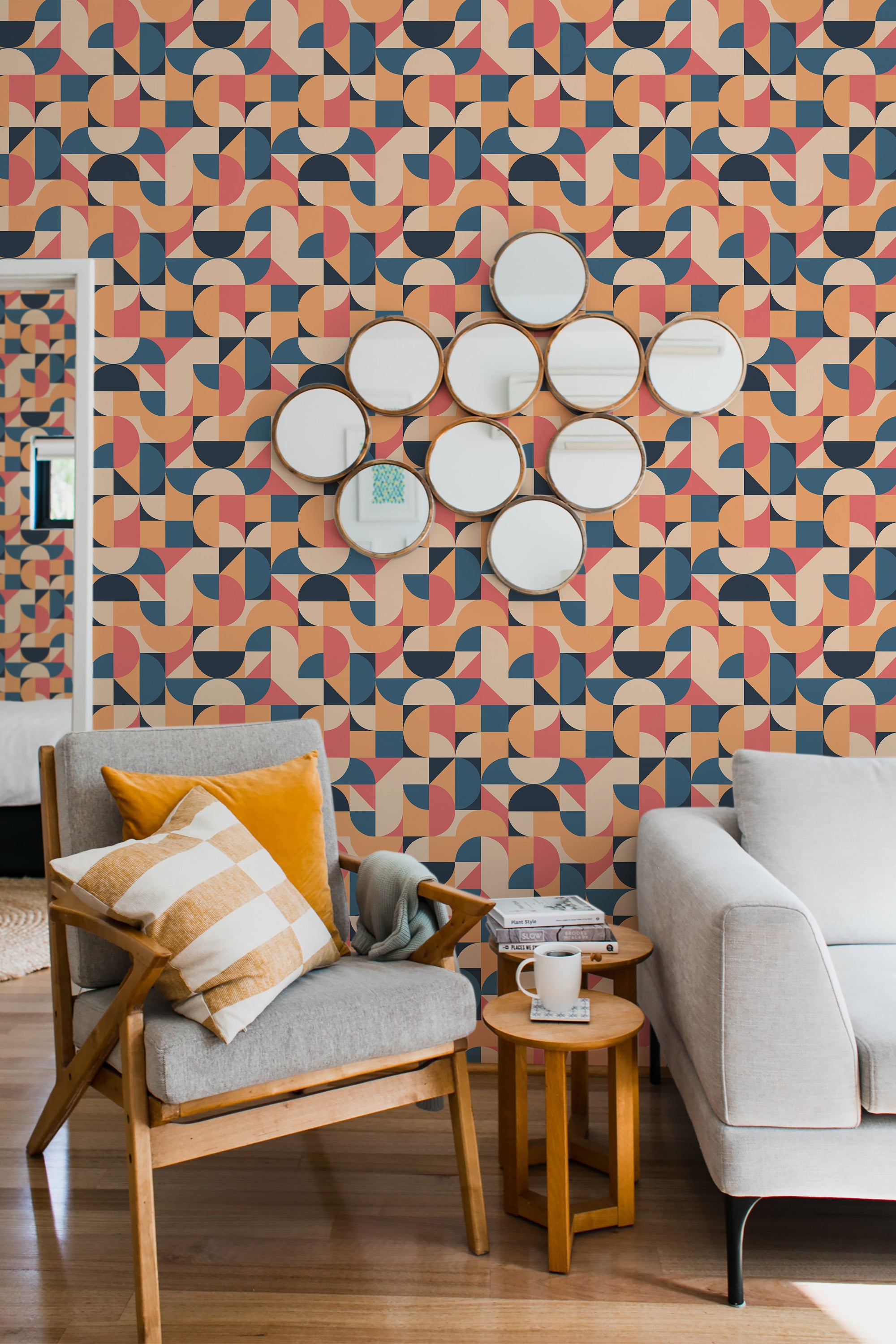 Wallpaper with bold, colorful geometric shapes in various patterns and overlapping curves. The design uses a mix of orange, pink, navy blue, and beige tones with a retro, funky aesthetic. The shapes create a vibrant, dynamic effect across the wall, adding a lively and modern touch to the interior. Traditional wallpaper.