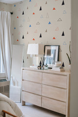 Wallpaper with a Triangle design in various colors, including black, red, blue, and brown, on a light beige background. Traditional wallpaper.