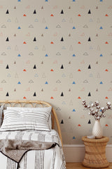 Self-adhesive wallpaper with a Triangle design in shades of black, red, blue, and beige scattered across a light beige background, adding a modern geometric touch to the room.