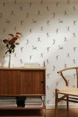 Self-adhesive wallpaper with a football design in subtle gray silhouettes of players in various action poses, set against a light cream background.