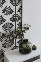 Self-adhesive wallpaper with a bold, black leaf pattern against a white background.