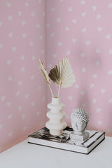 Self-adhesive pink wallpaper with a minimalist Mini heart pattern in white, adding a soft and charming touch to the room.