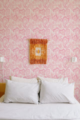 Self-adhesive wallpaper with a repeating heart pattern in various shades of pink, creating a playful and romantic ambiance in the room.