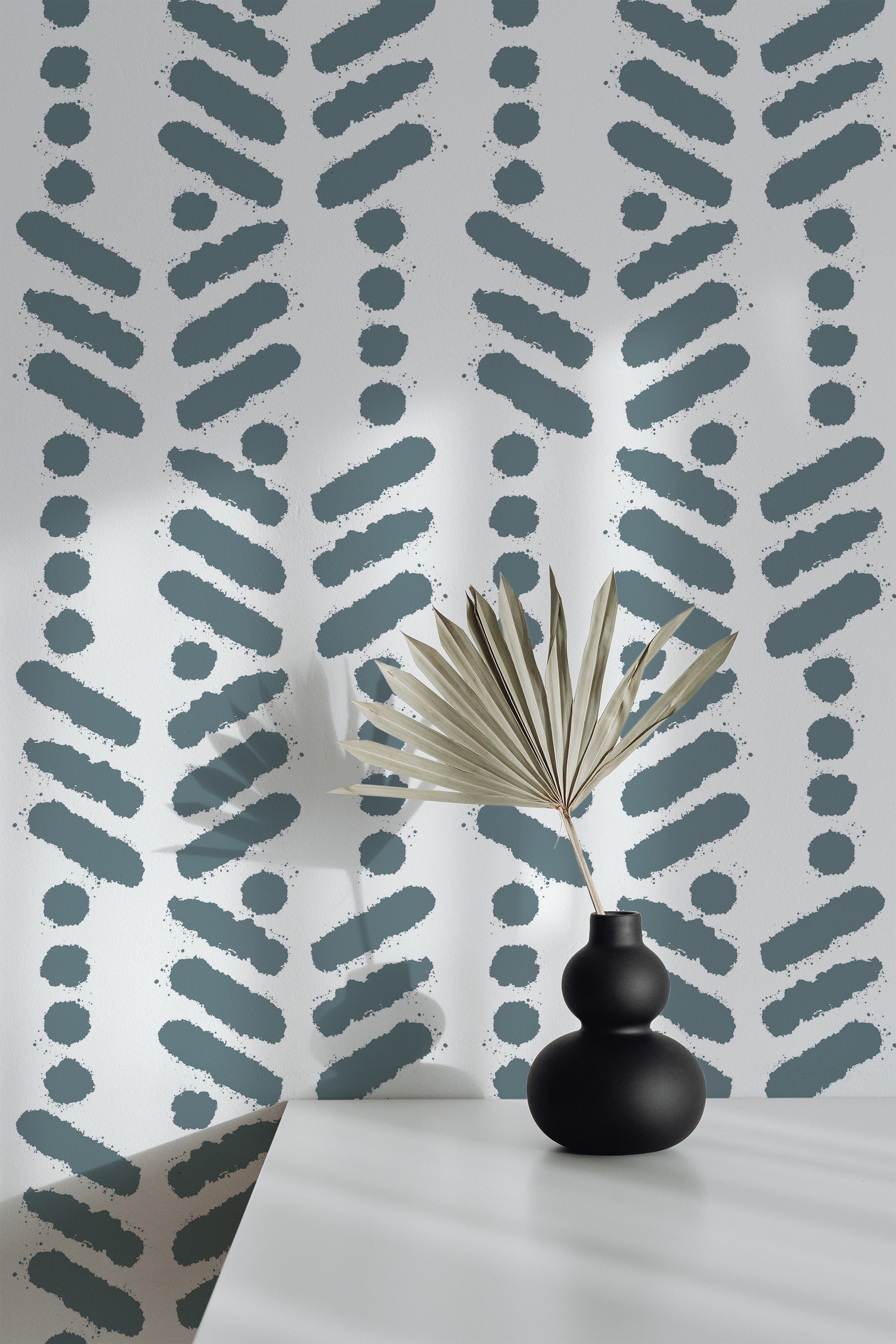 Self-adhesive wallpaper with a Herringbone brush stroke design in shades of dark teal against a light background, styled with abstract dotted and linear patterns.
