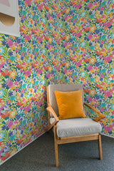 A vibrant floral wallpaper with colorful summer patterns in shades of pink, orange, blue, and green covers the wall, providing a lively and cheerful atmosphere. Traditional wallpaper.