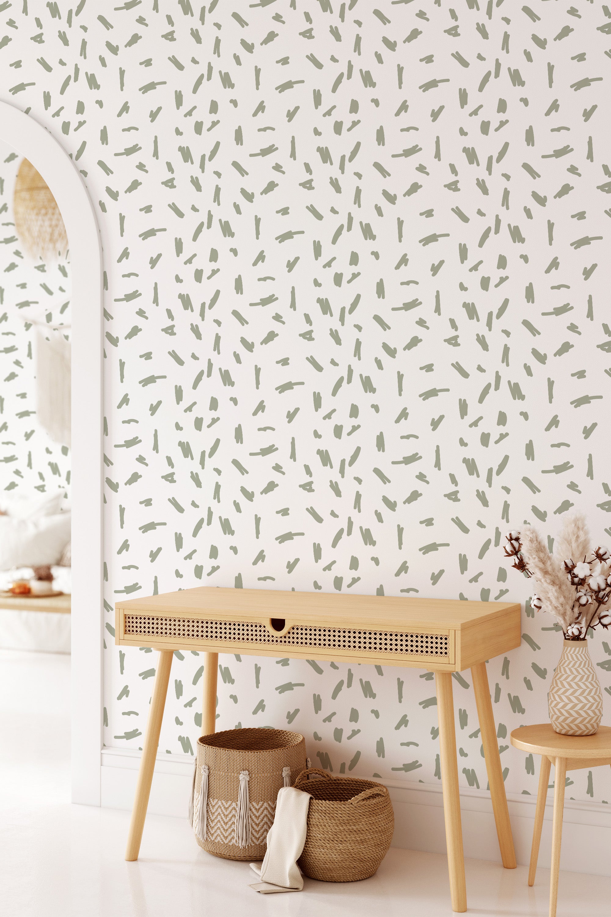 Room with a wall covered in white wallpaper adorned with subtle green brush strokes scattered in a random pattern, offering a modern yet timeless look. Traditional wallpaper.