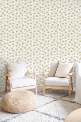 Gold, small floral patterns evenly distributed across a white background, creating a subtle yet elegant texture. Traditional wallpaper.