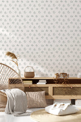 Wallpaper with delicate brush strokes resembling scattered leaves in a soft, earthy tone on a light background, blending seamlessly into the serene and earthy decor of the room, traditional wallpaper.