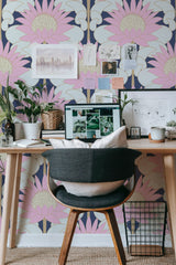 Self-adhesive Art Deco flower wallpaper with bold, geometric floral patterns in shades of pink, cream, and gold on a navy blue background, enhancing the room's vintage charm.