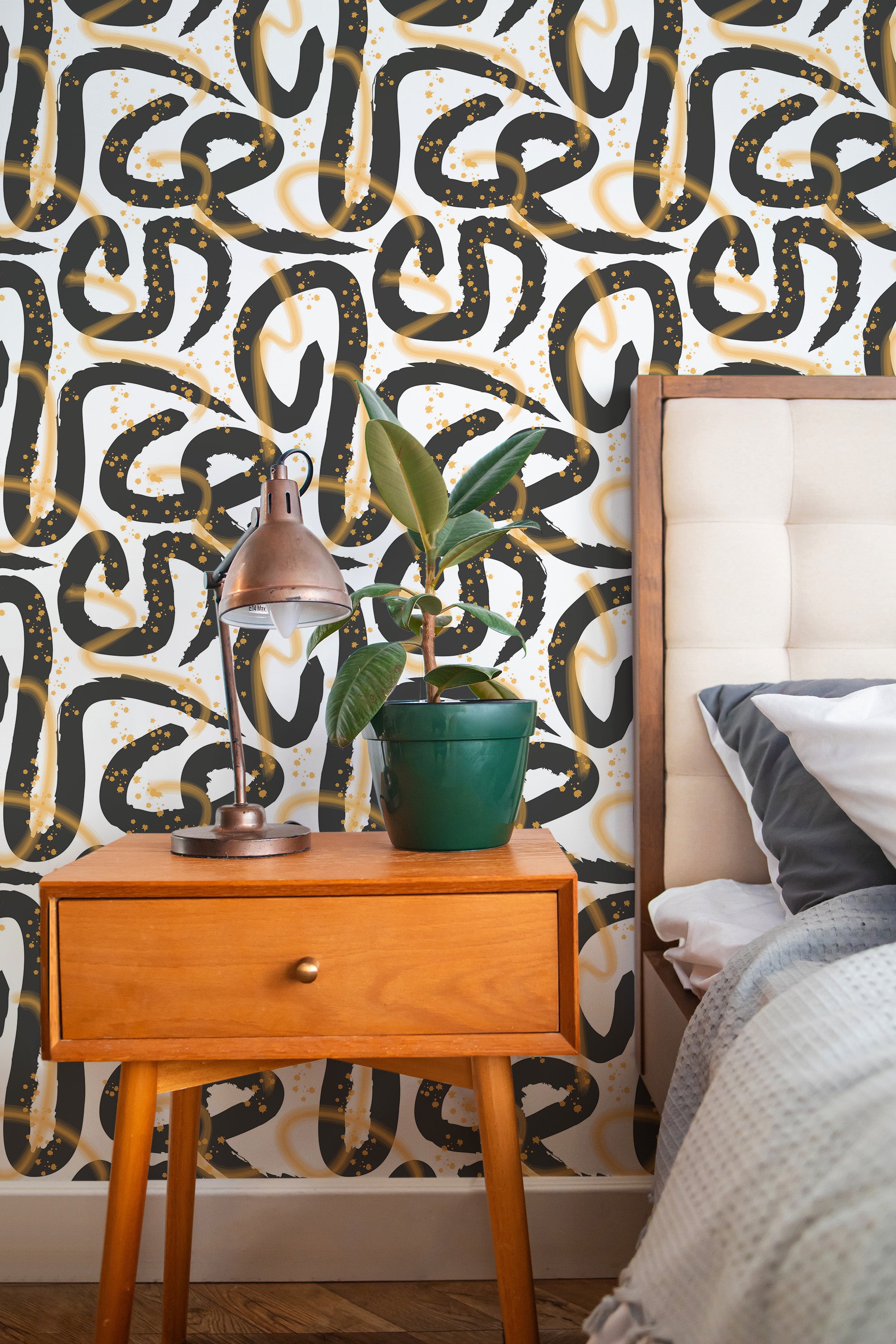 Self-adhesive wallpaper with a Gestural abstraction design, combining fluid black and gold brushstrokes with dynamic curves and dotted accents, set against a white background.