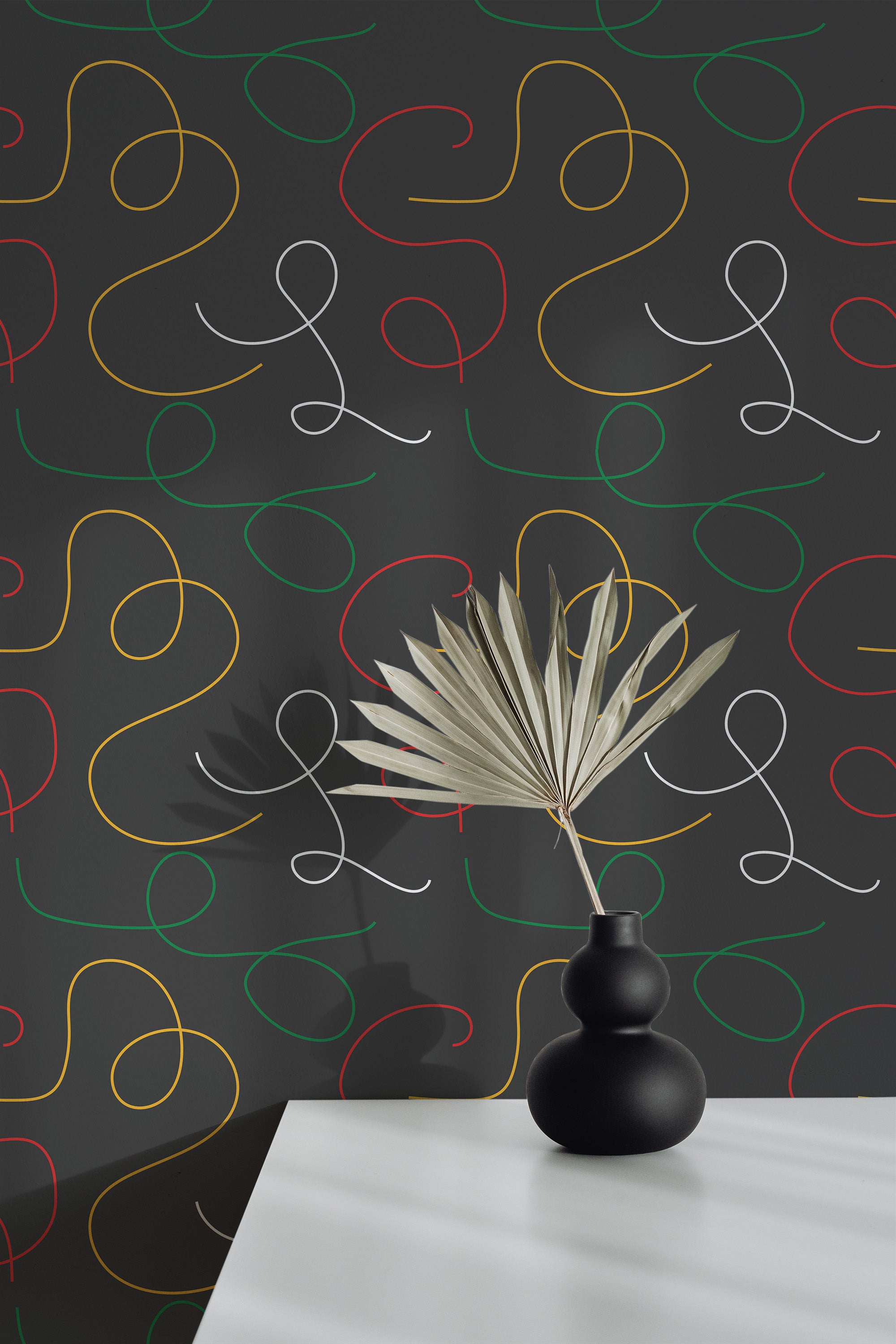 Self-adhesive wallpaper with a bold black background and continuous swirling lines in red, yellow, green, and white. The design intertwines curving loops of varying sizes, creating a lively, modern aesthetic.