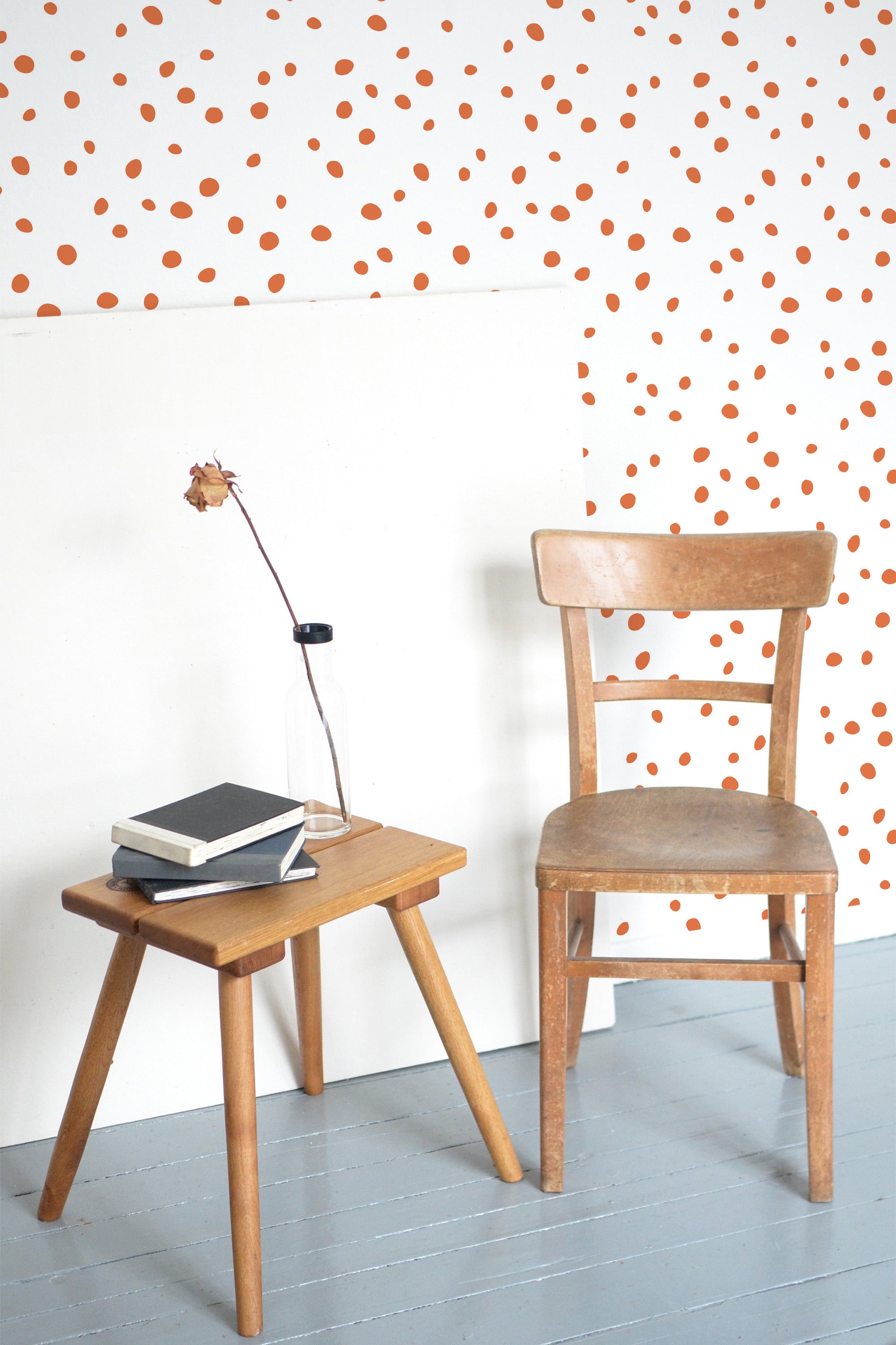 Self-adhesive wallpaper with a pattern of small orange spots scattered evenly across a white background, creating a lively and playful atmosphere in the room.