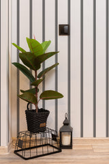 Self-adhesive wallpaper with a classic striped design in alternating black and white vertical lines. The pattern adds a touch of elegance and a sense of height to the room.