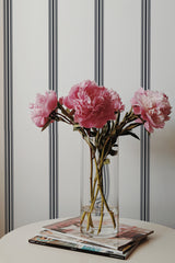 Self-adhesive wallpaper with an aesthetic striped print in bold black stripes on a white background, adding a modern and elegant touch to the room.