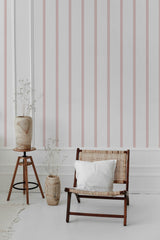 Vertical pink stripes on a white background creating a pattern that adds an elegant and symmetrical look to the walls, creating a sense of height and sophistication in the room. Traditional wallpaper.