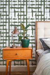 Self-adhesive wallpaper with a Brush stroke grid design in green, with overlapping strokes creating an abstract, modern pattern on a white background.