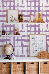 Self-adhesive wallpaper with bold brush strokes in a grid-like pattern, combining shades of purple on a white background.