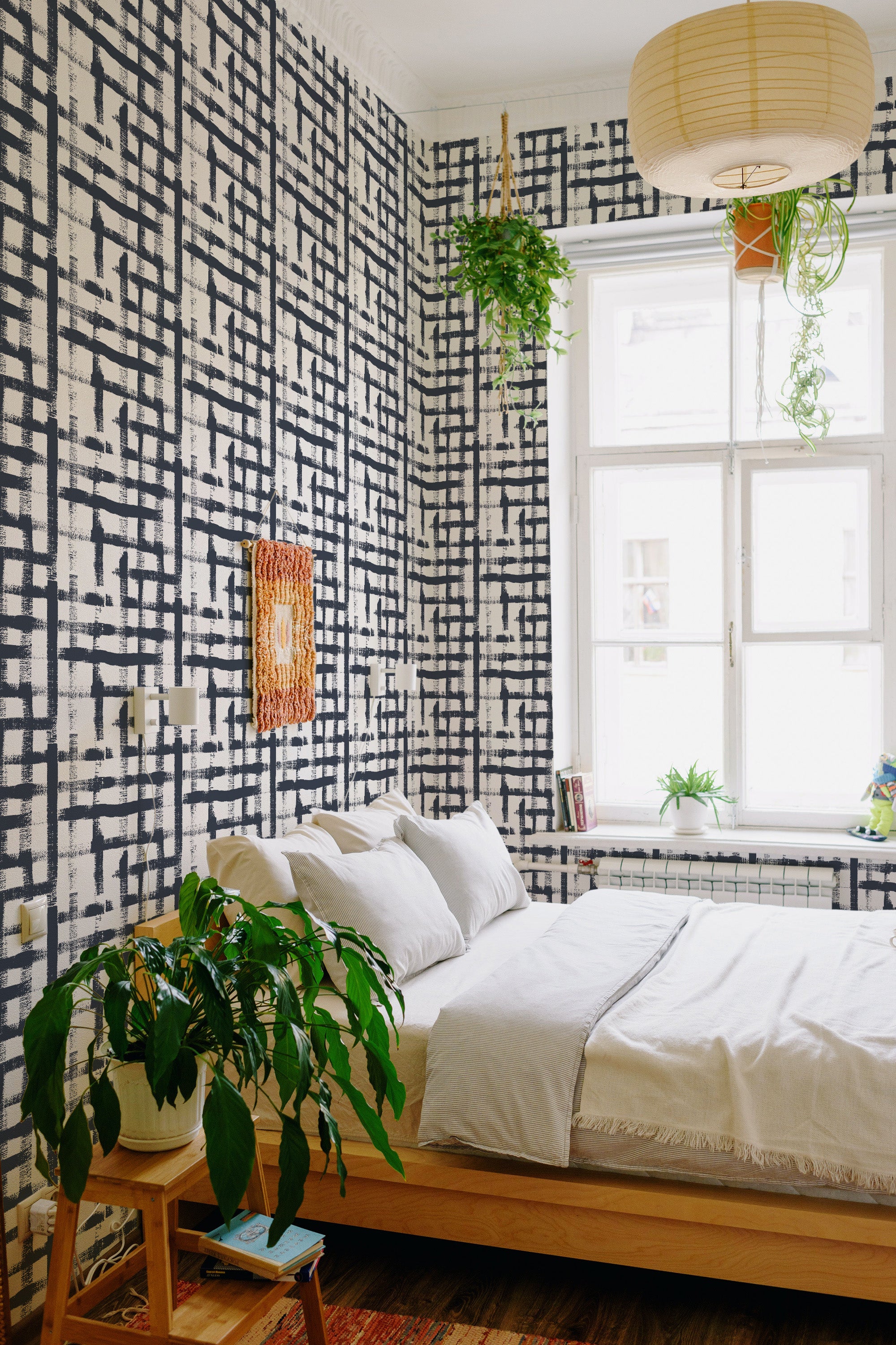 The wallpaper has a Navy blue brush stroke pattern with intersecting lines creating a grid-like, abstract design. The bold strokes contrast vividly against a light background, adding a modern touch to the room. Traditional wallpaper.