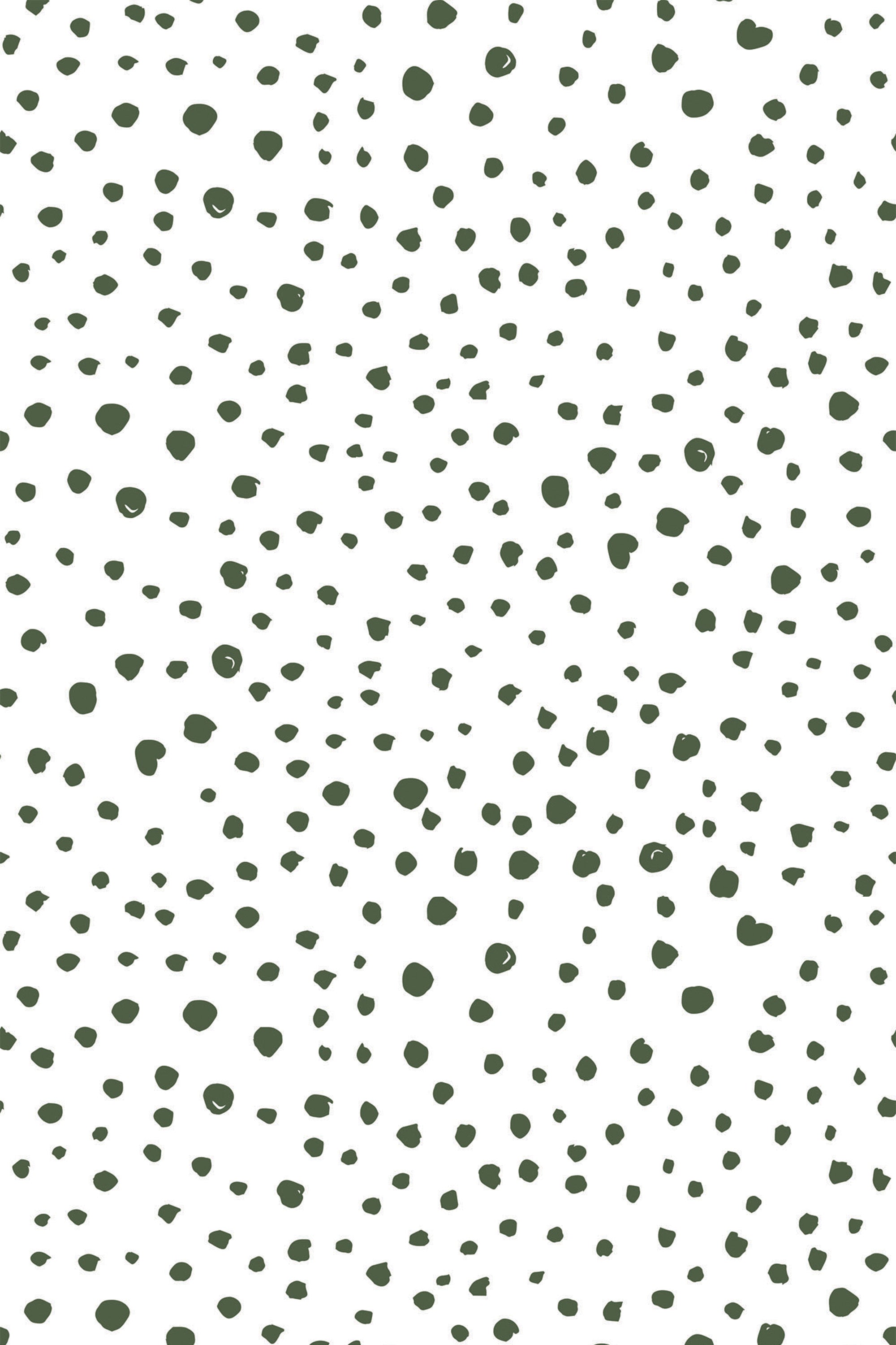 Green speckled dots of varying sizes scatter randomly across a white background, creating a playful and modern pattern. Peel and stick removable wallpaper.
