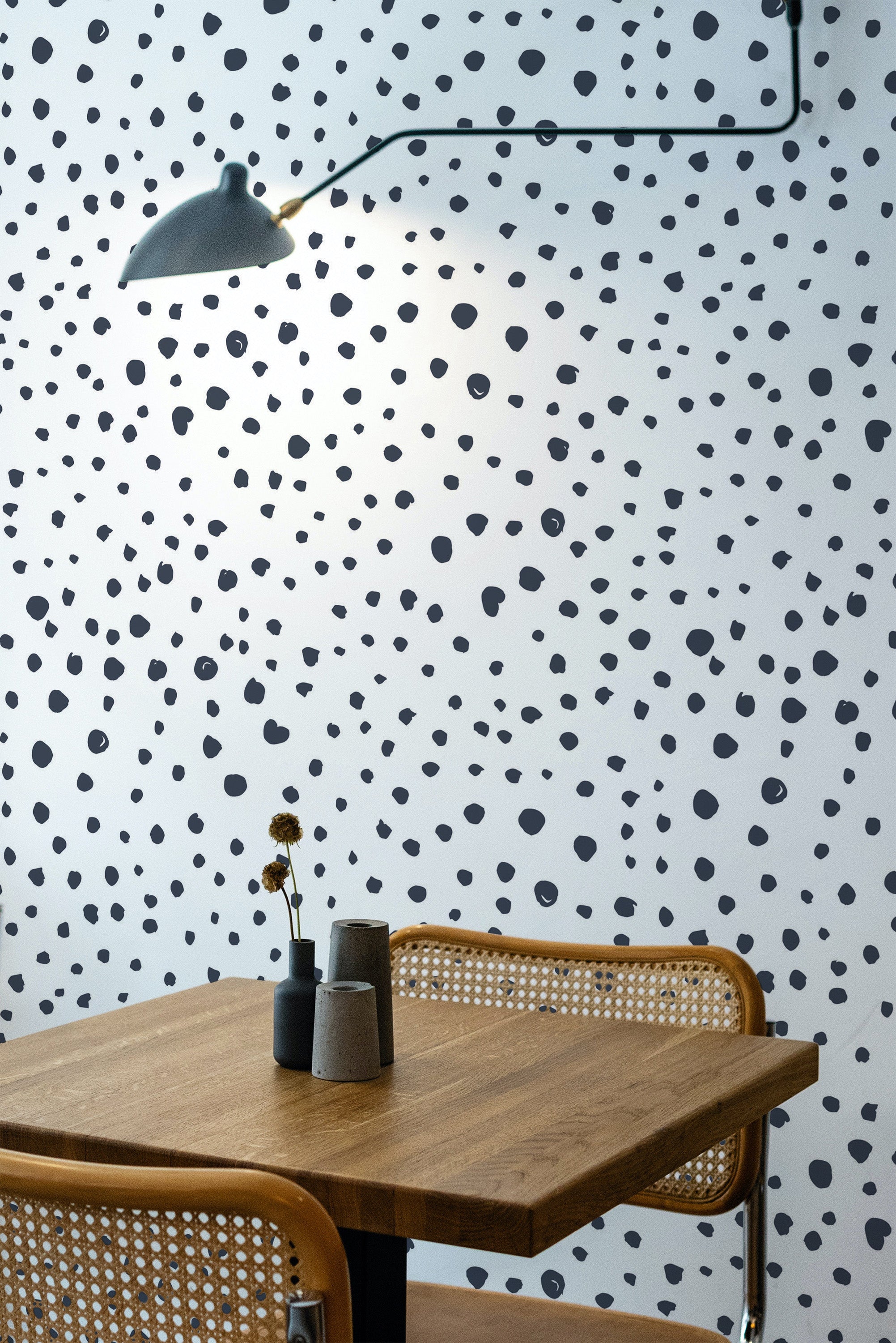 Self-adhesive Dalmatian print wallpaper with irregular black spots scattered across a white background, creating a playful and modern look.