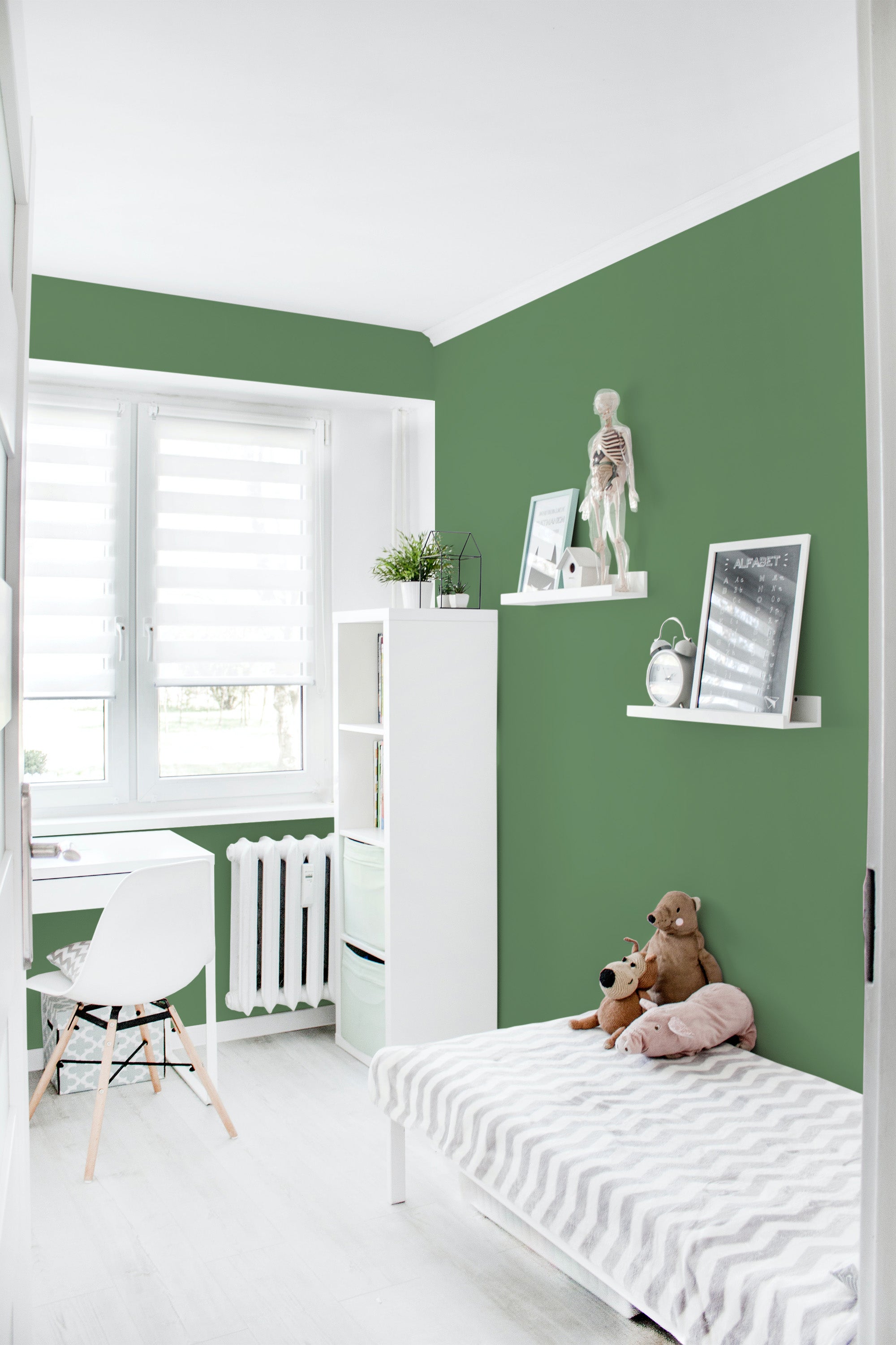 A room with walls covered in a smooth, solid dark green wallpaper that contrasts with the white furniture and decor, creating a calm and elegant atmosphere. Traditional wallpaper.