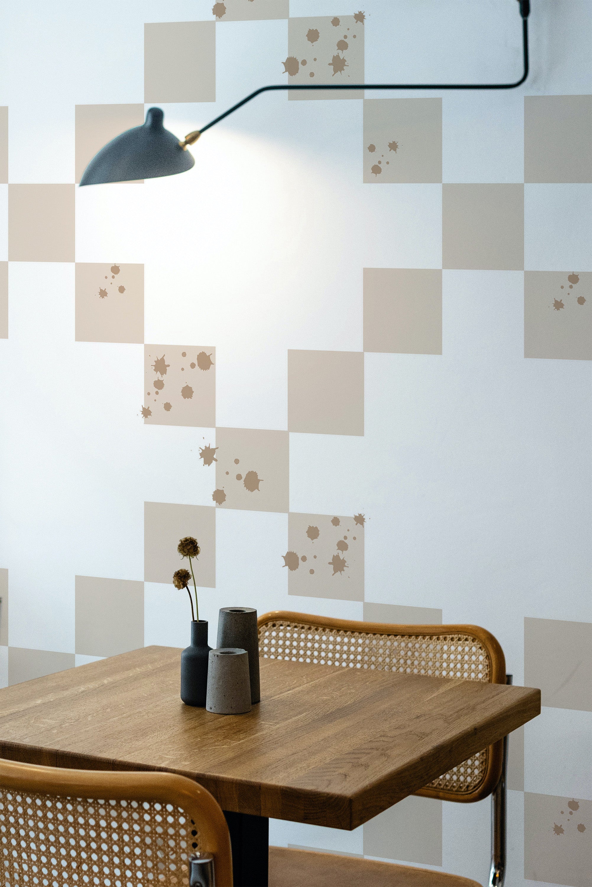 Self-adhesive wallpaper with a minimal tile squares pattern in neutral tones, incorporating subtle splatter accents.