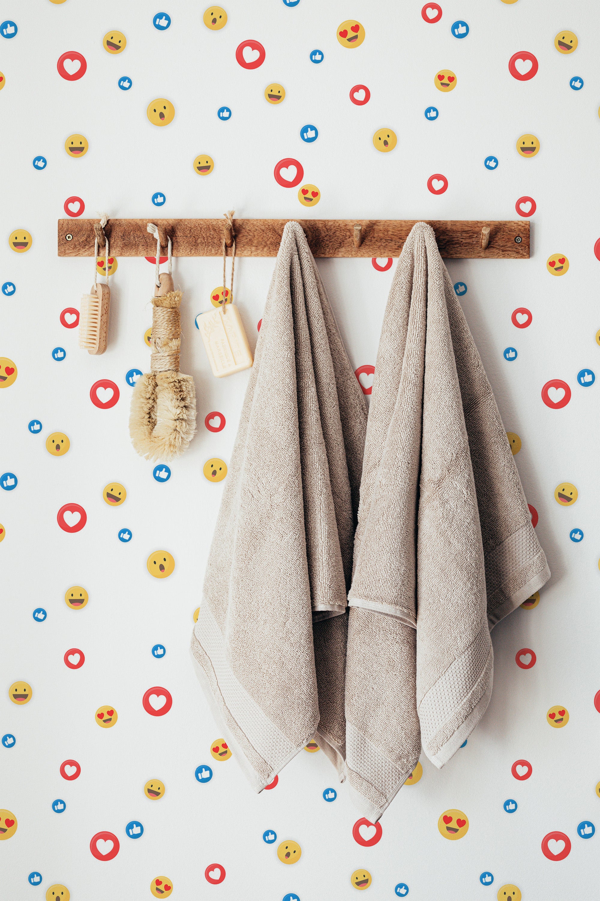 Self-adhesive wallpaper with a playful pattern of social media icons, including smiley faces, heart symbols, and thumbs-up like badges on a white background.