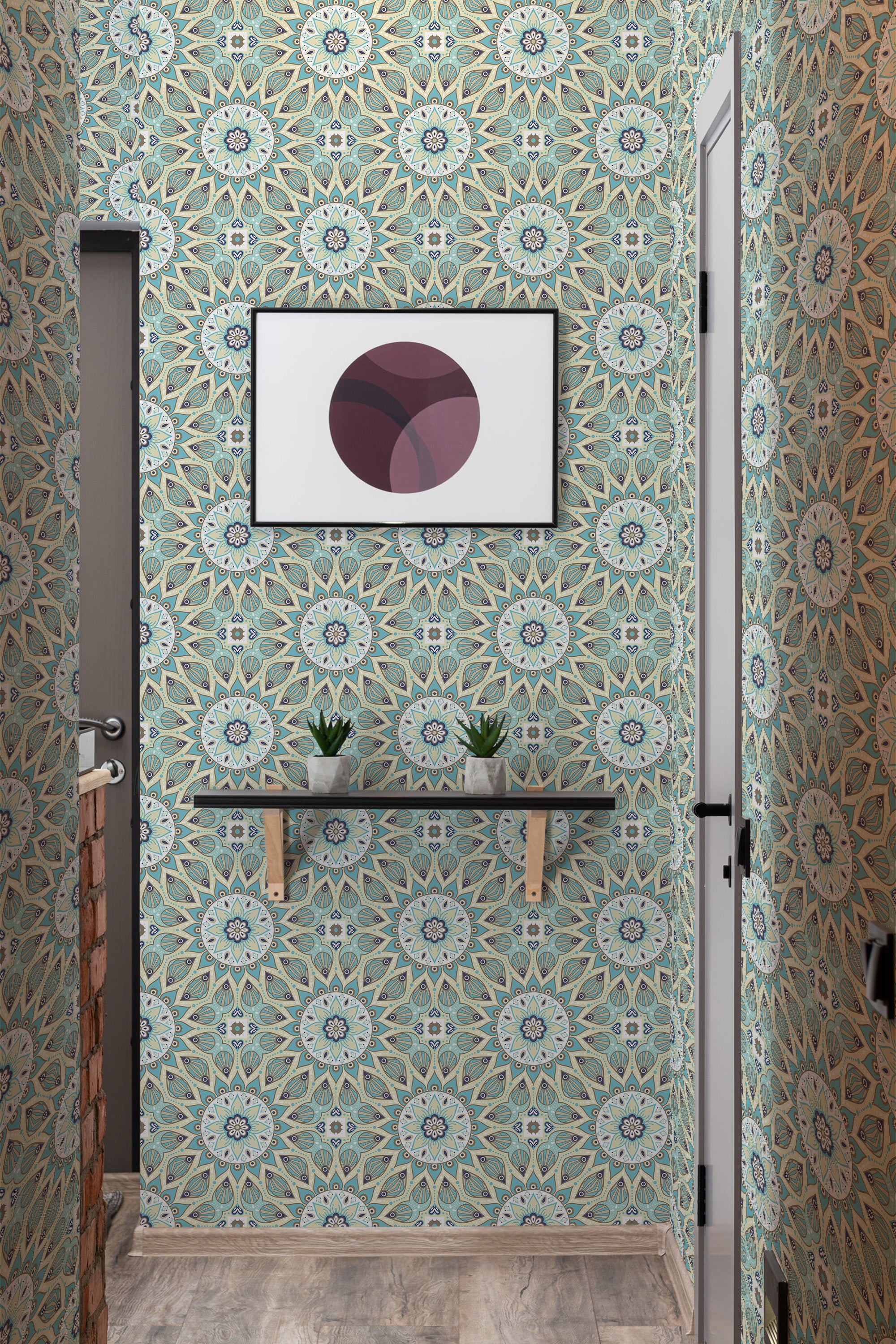 The wallpaper design has intricate mandala patterns in soothing shades of green, blue, and beige, with detailed geometric shapes and floral elements creating a harmonious and symmetrical look. The image also shows a small shelf with plants and a framed abstract art piece on the wall. Traditional wallpaper.