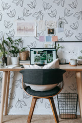 Self-adhesive wallpaper with a minimal floral design, featuring simple black line-drawn leaves on a white background, creating a modern and clean aesthetic.