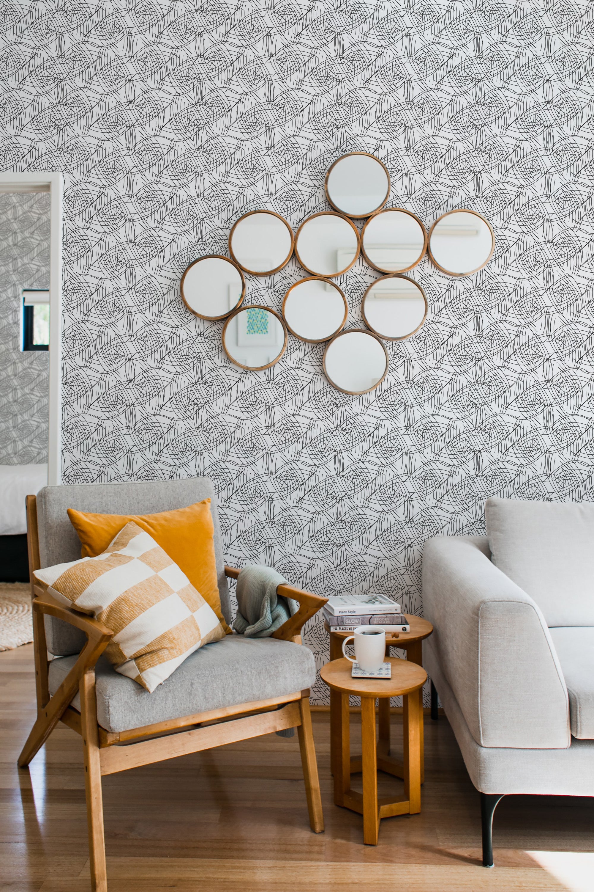 Line art wallpaper with intricate, interconnected geometric patterns in black on a white background, complementing the modern but cozy decor of the room, traditional wallpaper.